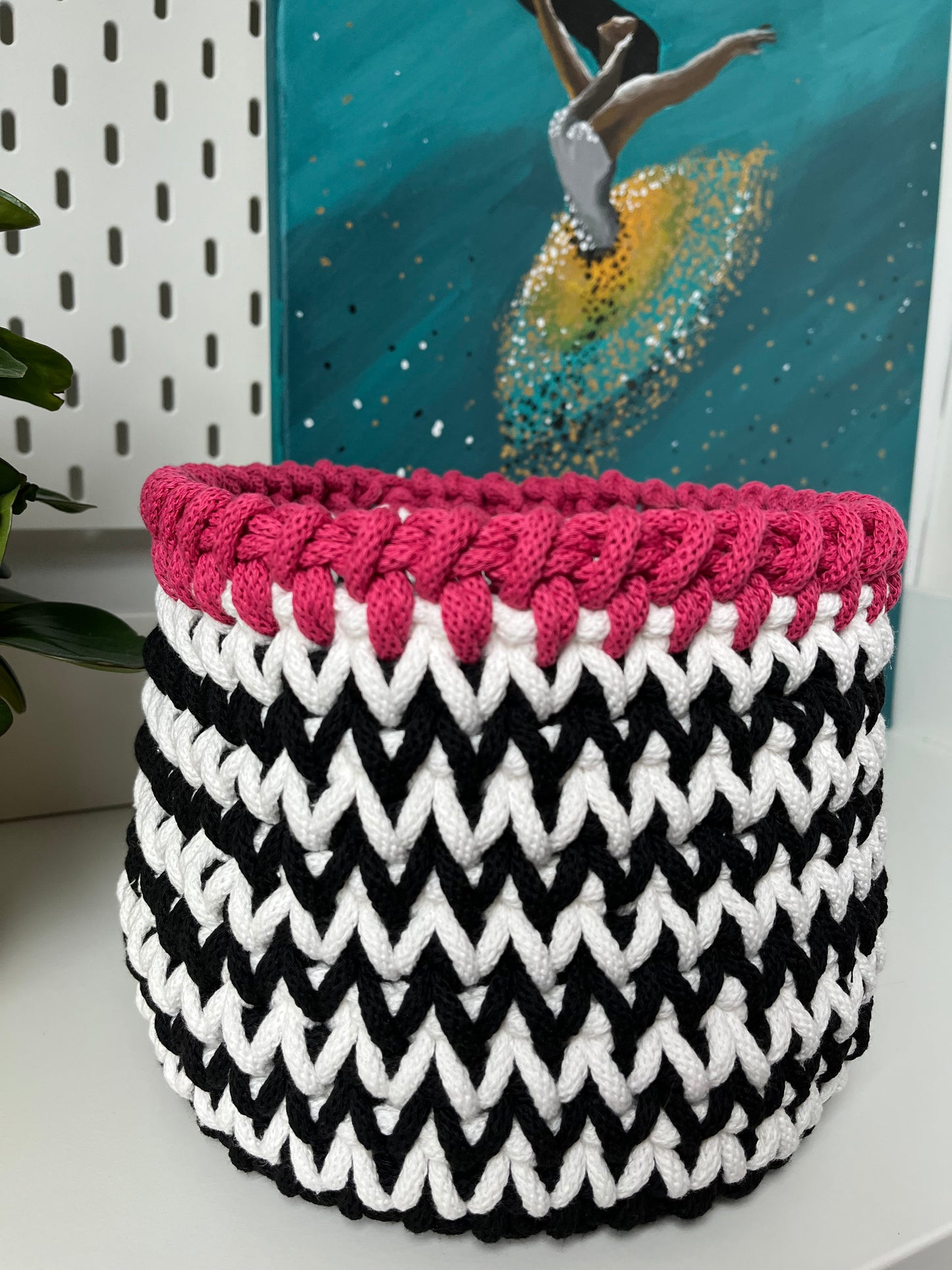 Handmade black and white storage basket with a soft pink trim, crafted from recycled cotton cord. A stylish solution for organising everyday items throughout your home.