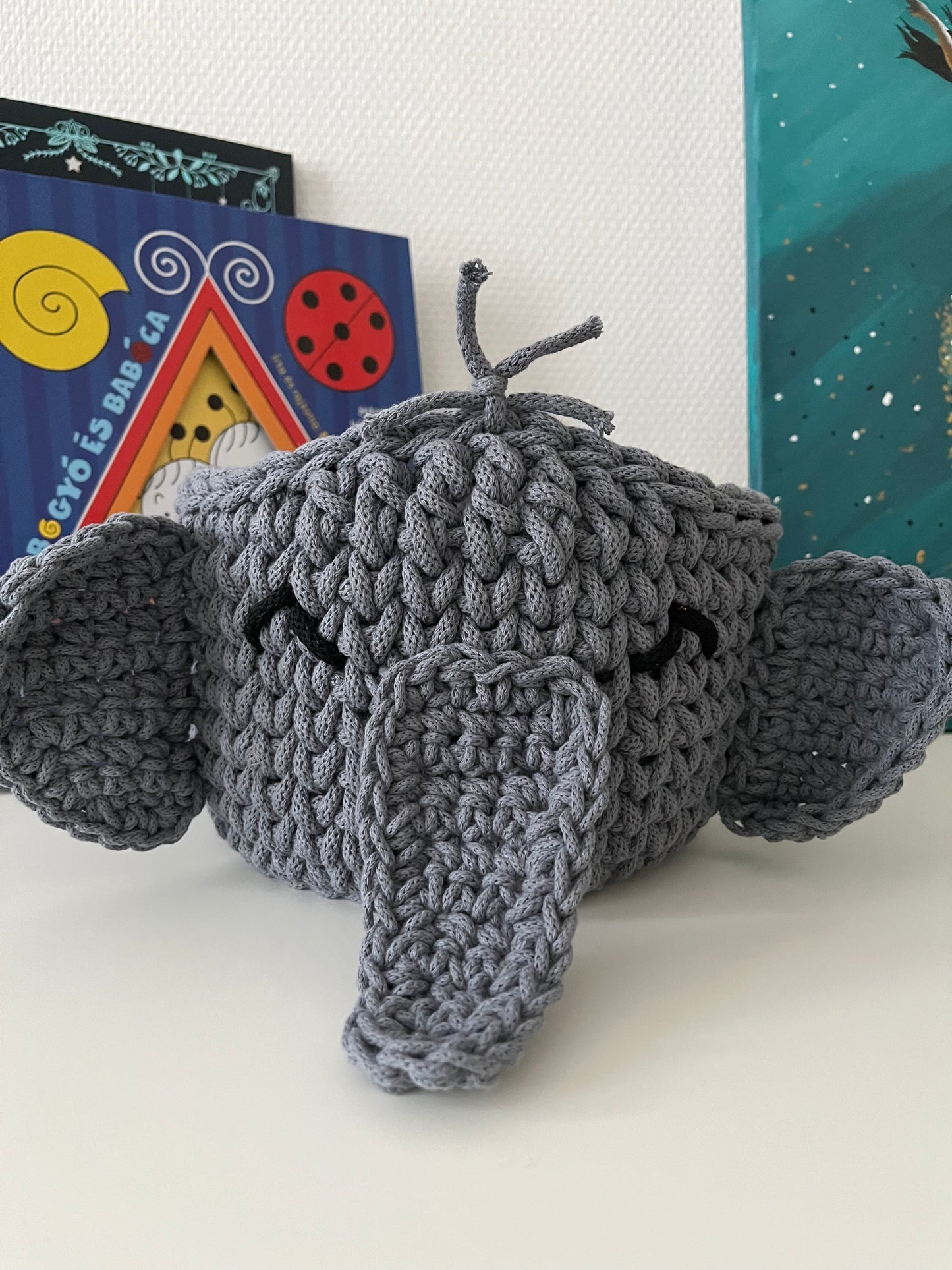 Handmade elephant basket made from recycled cotton cord for toy storage in kids room.