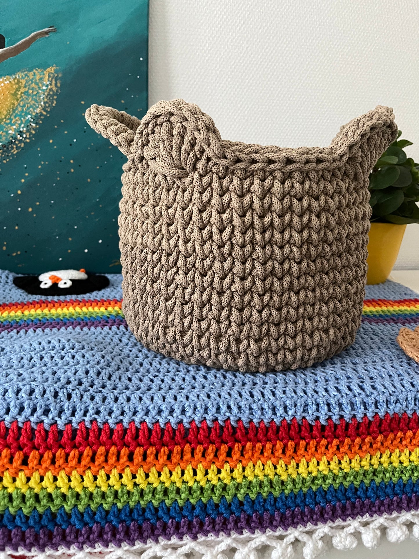 Handmade bear basket made from recycled cotton cord for toy storage in kids room.