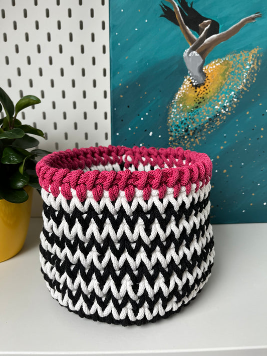 Handmade black and white storage basket with a soft pink trim, crafted from recycled cotton cord. A stylish solution for organising everyday items throughout your home.