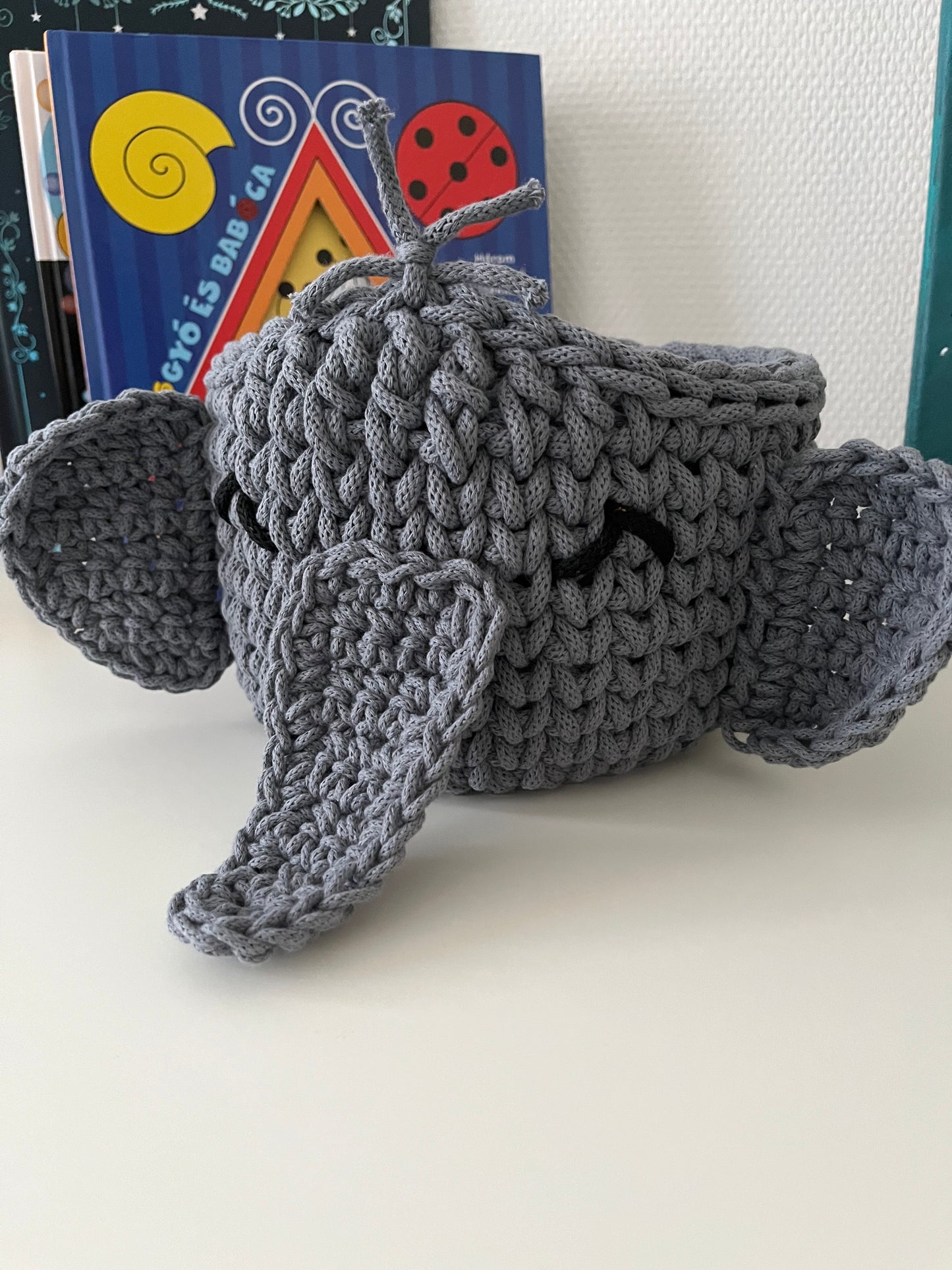 Handmade elephant basket made from recycled cotton cord for toy storage in kids room.