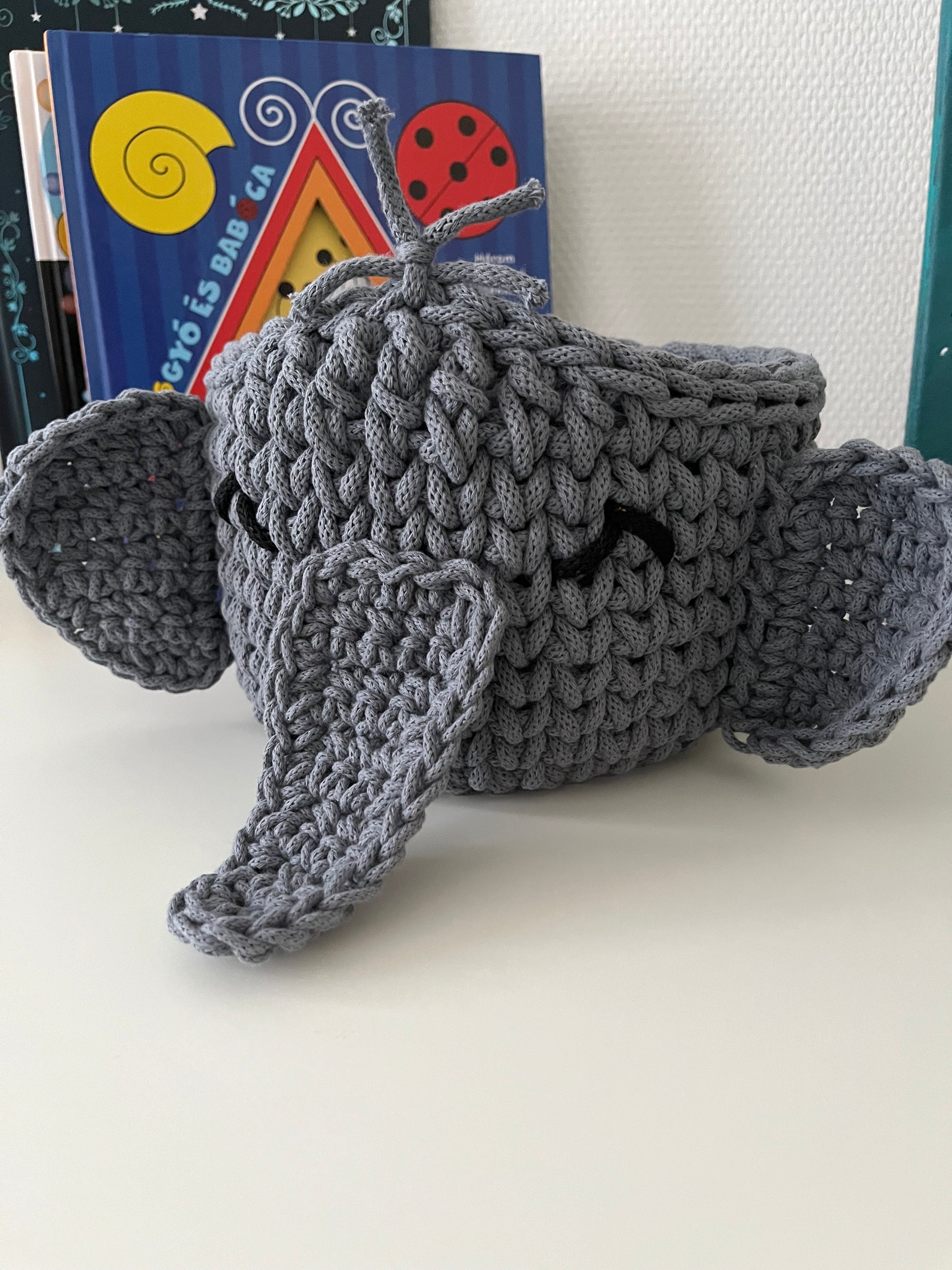 Handmade elephant basket made from recycled cotton cord for toy storage in kids room.