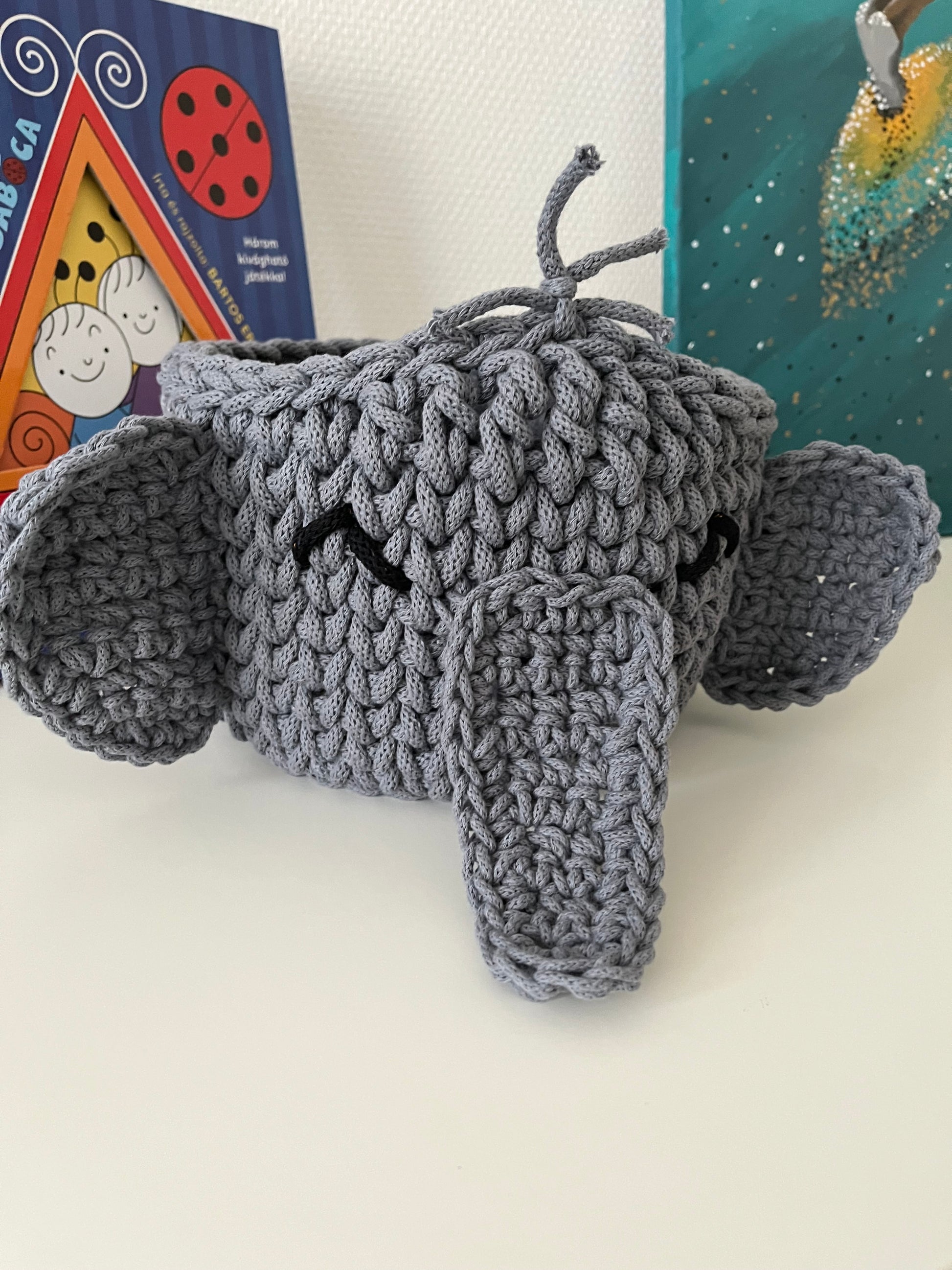 Handmade elephant basket made from recycled cotton cord for toy storage in kids room.