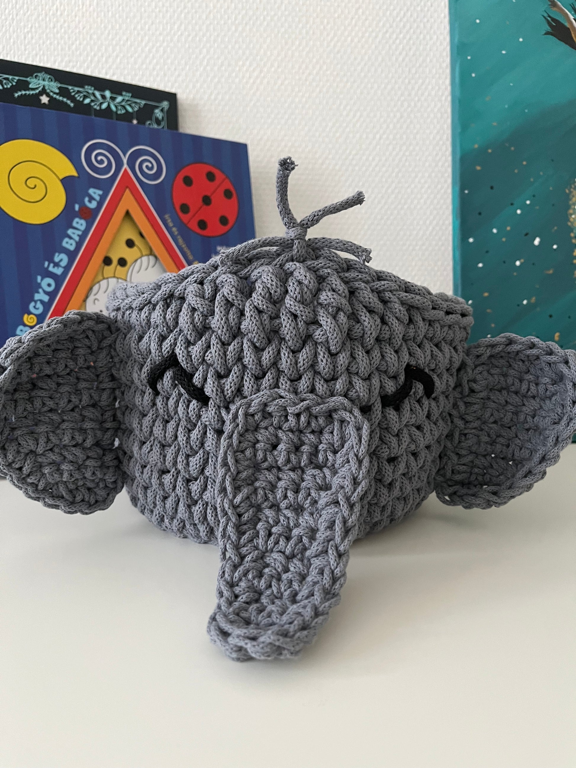 Handmade elephant basket made from recycled cotton cord for toy storage in kids room.