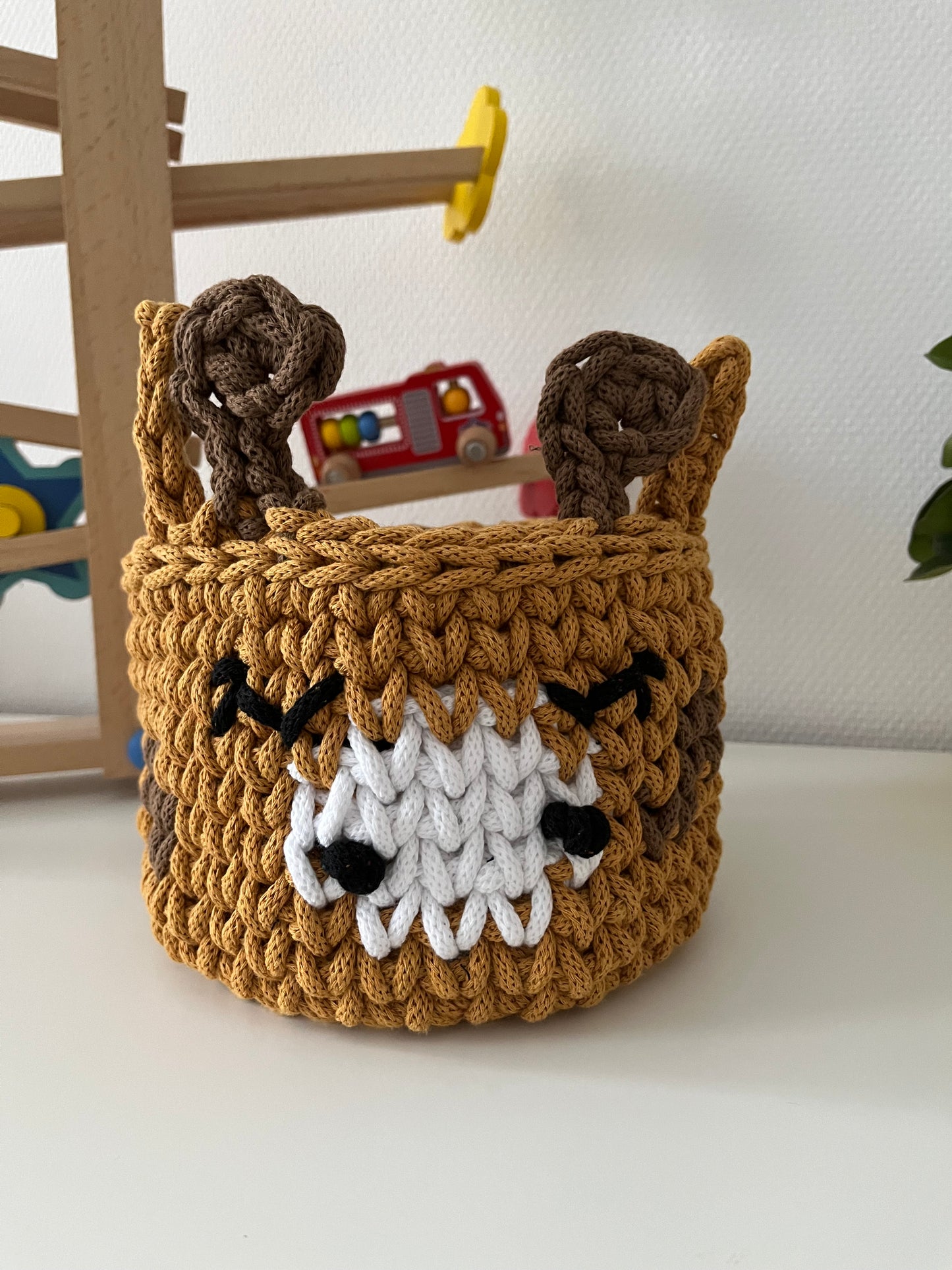 Handmade giraffe basket made from recycled cotton cord for toy storage in kids room
