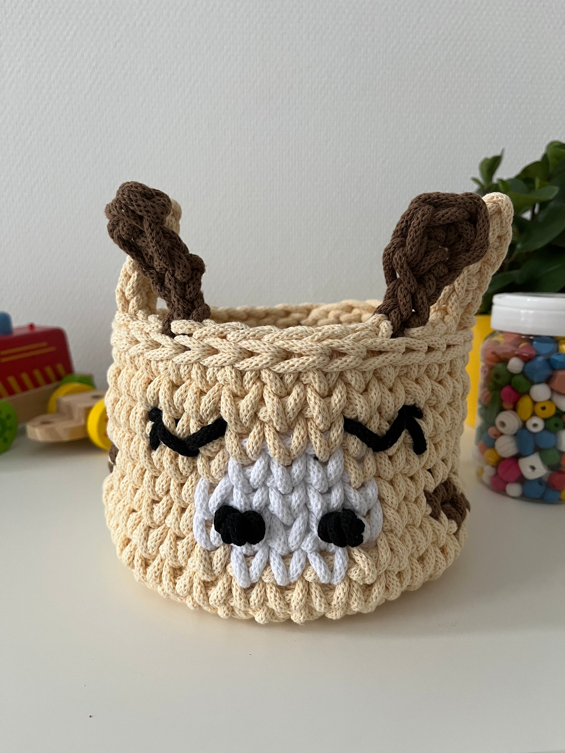 Handmade giraffe basket made from recycled cotton cord for toy storage in kids room