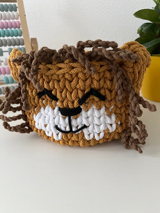 Handmade lion basket made from recycled cotton cord for toy storage in kids room. 
