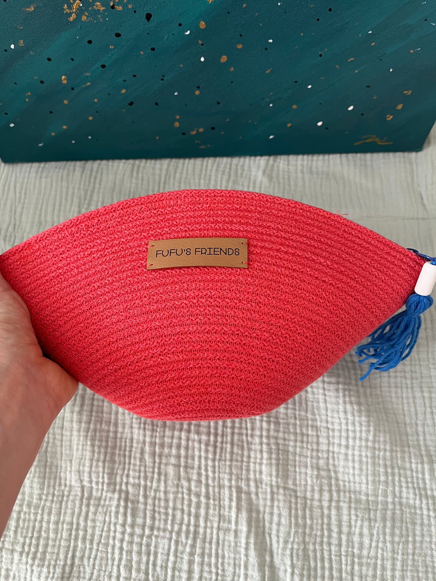 Toiletry bag with structured shape and textured accent detail.