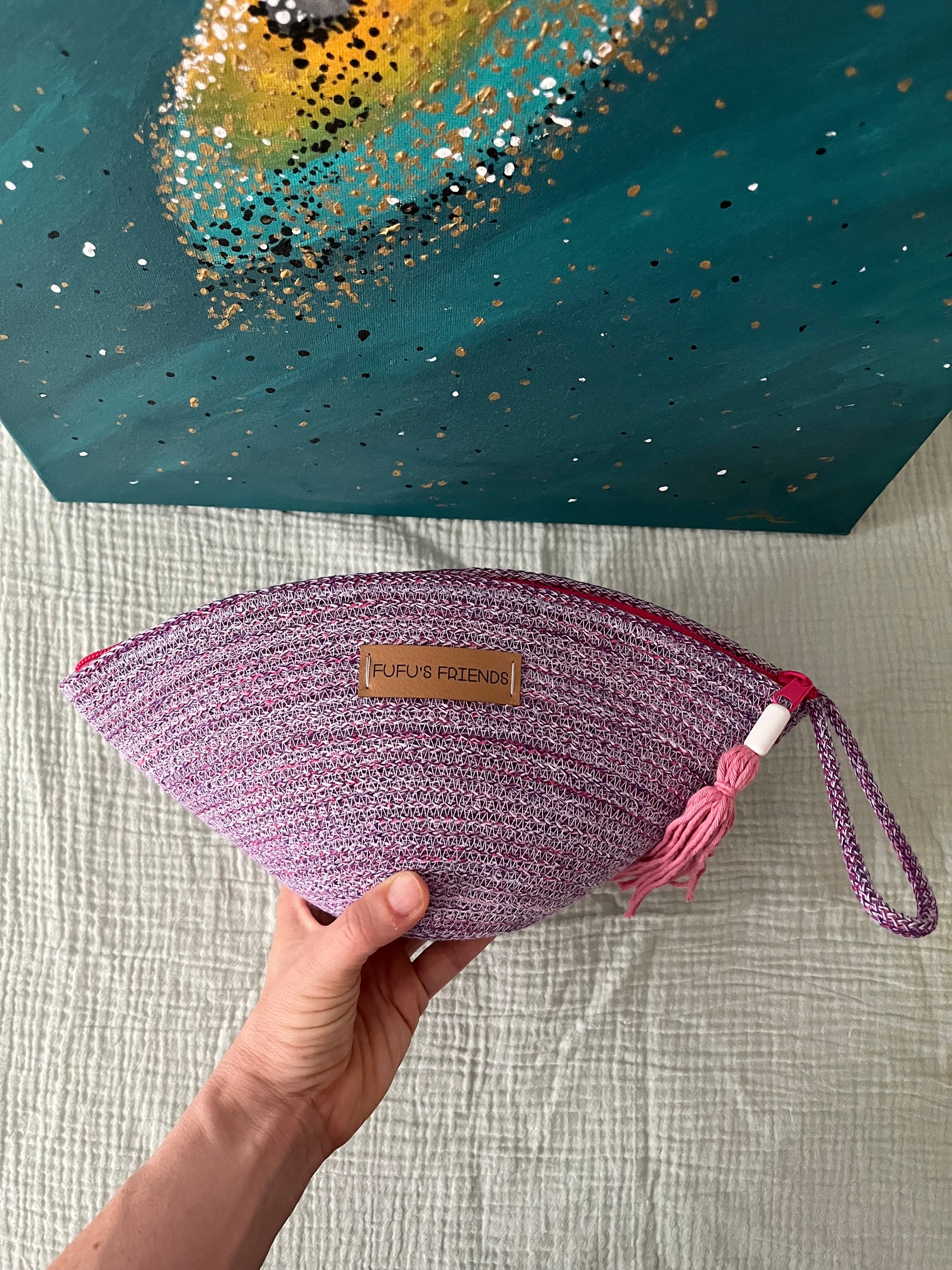 Colourful shell pouch made from durable cord for everyday essentials.