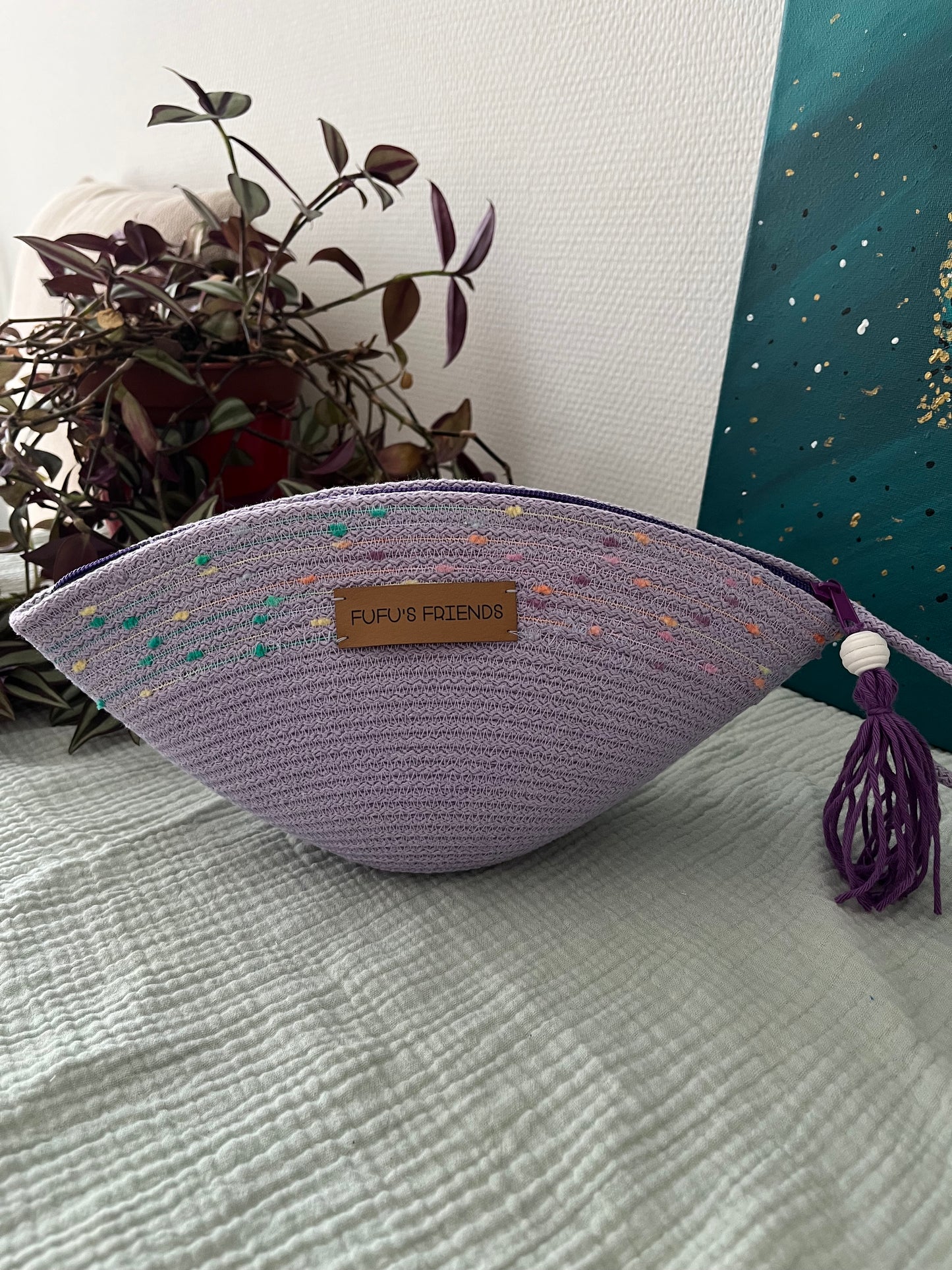 Handmade boho-inspired cosmetic bag with decorative textured detail.