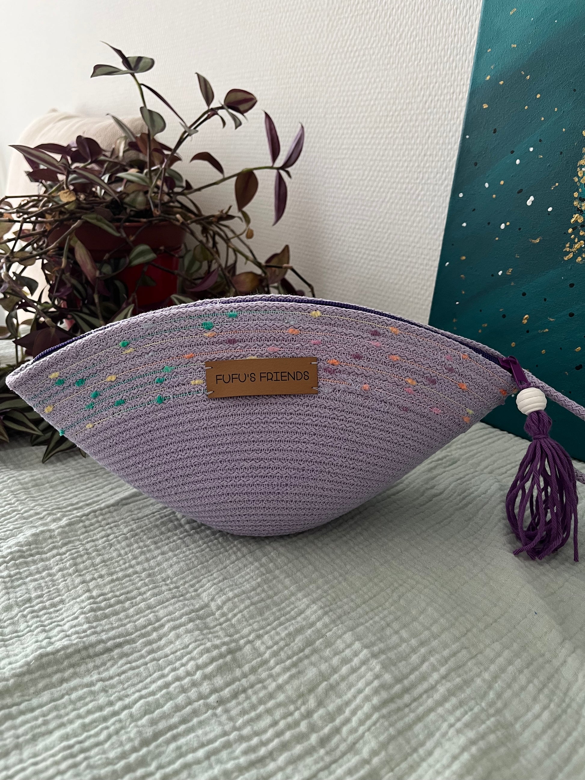 Handmade boho-inspired cosmetic bag with decorative textured detail.