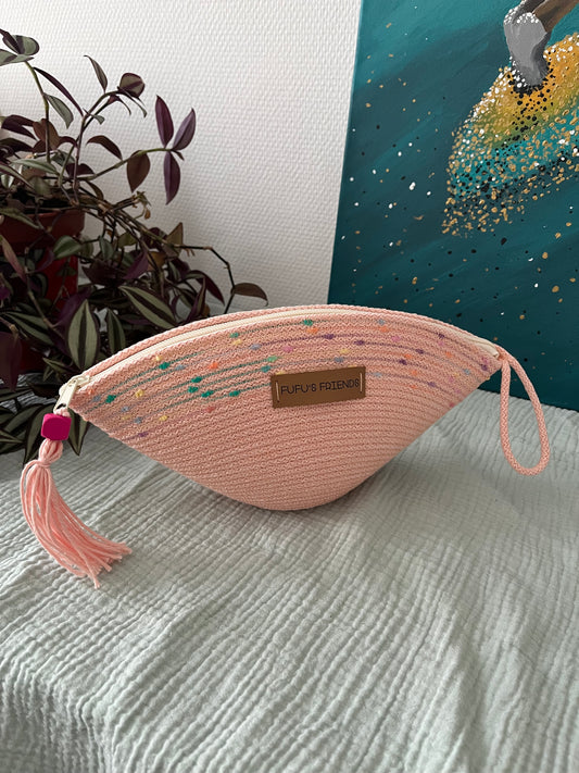 Handmade shell-shaped crochet pouch in soft pink with zipper closure.